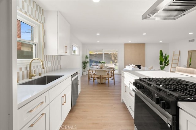 1825 W Carlton Pl, Santa Ana, CA 92704 - kitchen with gas range, a sink, dishwasher, light wood-style flooring, and recessed lighting