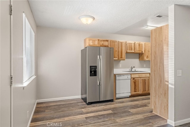 1256 Warner St, Chico, CA 95926 - kitchen featuring stainless steel refrigerator with ice dispenser, white dishwasher, dark wood-style flooring, a sink, and a textured ceiling