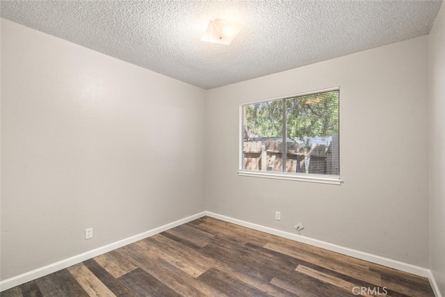 1256 Warner St, Chico, CA 95926 - empty room with dark wood-style floors, baseboards, and a textured ceiling