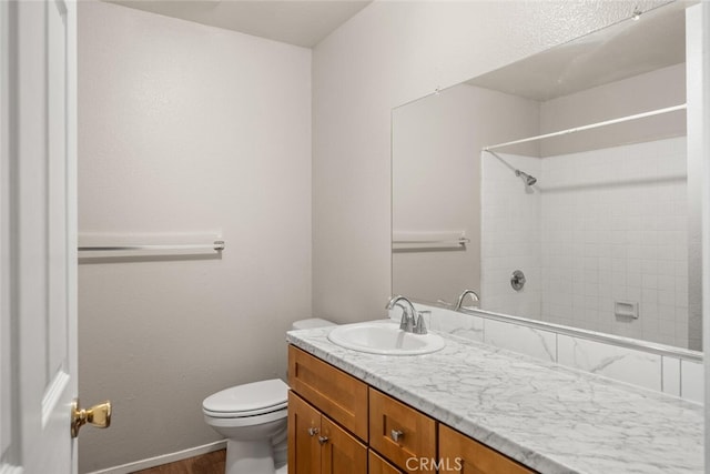1256 Warner St, Chico, CA 95926 - bathroom featuring toilet, vanity, a shower, wood finished floors, and baseboards