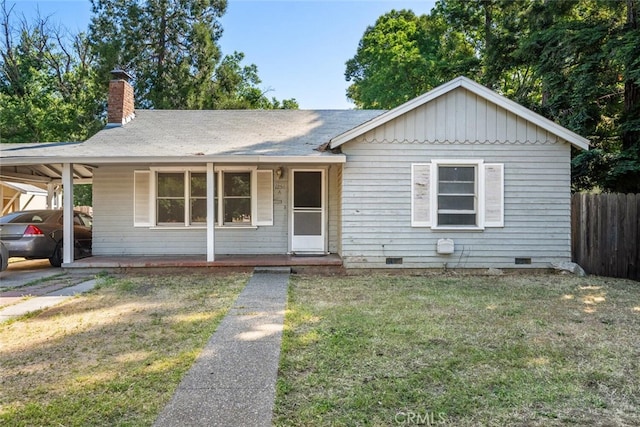 1256 Warner St, Chico, CA 95926 - view of front facade featuring crawl space, a chimney, a carport, and covered porch