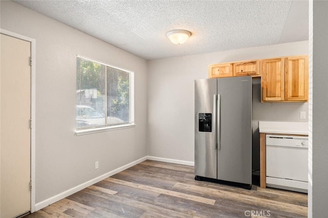 1256 Warner St, Chico, CA 95926 - kitchen featuring dishwasher, stainless steel fridge with ice dispenser, light wood finished floors, a textured ceiling, and light brown cabinetry