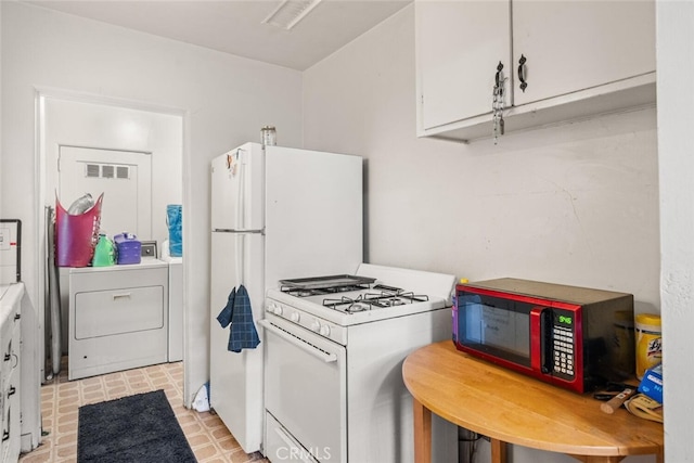1256 Warner St, Chico, CA 95926 - kitchen with white gas range, washer / clothes dryer, white cabinetry, and light countertops