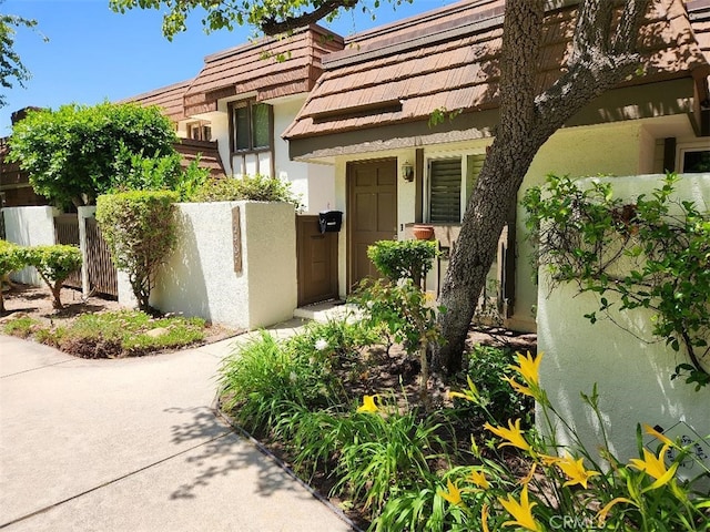 10407 Larwin Ave, Chatsworth, CA 91311 - view of exterior entry featuring stucco siding and a gate