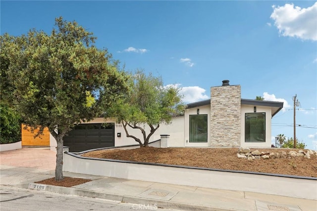 2105 Noble View Dr, Rancho Palos Verdes, CA 90275 - view of front facade with stucco siding, a chimney, a garage, and driveway