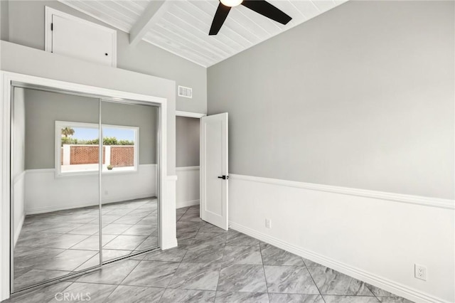 unfurnished bedroom featuring marble finish floors, a closet, a ceiling fan, and baseboards