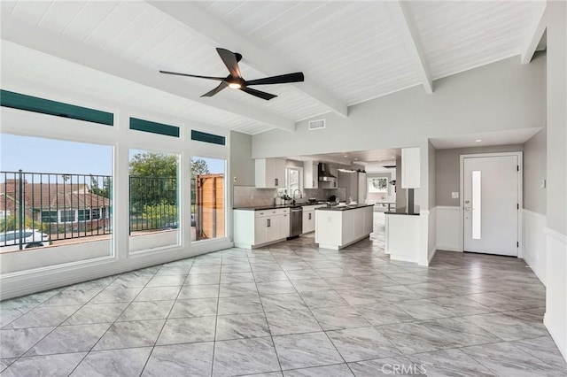 2105 Noble View Dr, Rancho Palos Verdes, CA 90275 - unfurnished living room featuring a ceiling fan, beam ceiling, healthy amount of natural light, light marble finish floors, and a sink