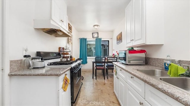 kitchen featuring black gas range oven, stainless steel microwave, under cabinet range hood, white cabinets, and a sink