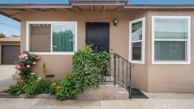view of exterior entry with stucco siding
