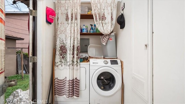 clothes washing area with washing machine and clothes dryer