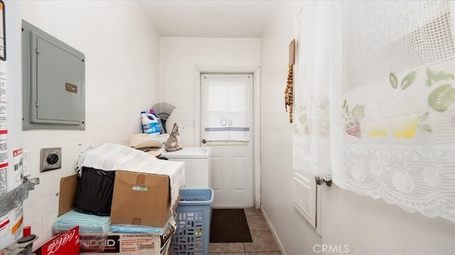 washroom featuring tile patterned flooring, washer / dryer, and electric panel