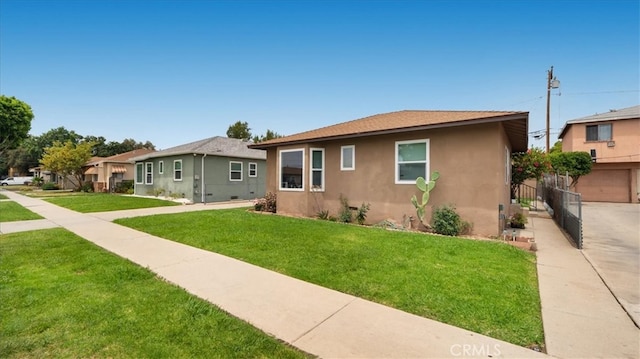 view of front facade featuring stucco siding and a front lawn