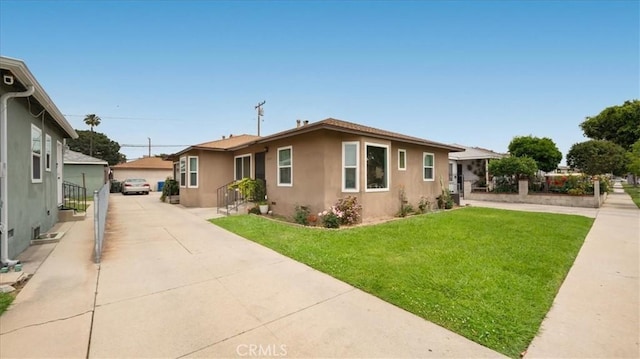 view of front of home with stucco siding and a front lawn