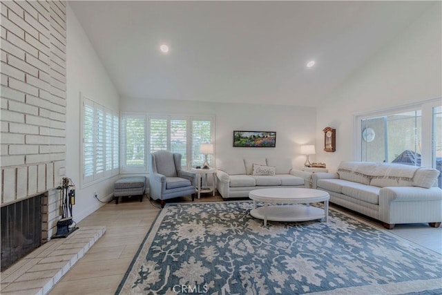 5855 Via Sonora Unit 39, Yorba Linda, CA 92887 - living room with high vaulted ceiling, a brick fireplace, light wood-style floors, and recessed lighting