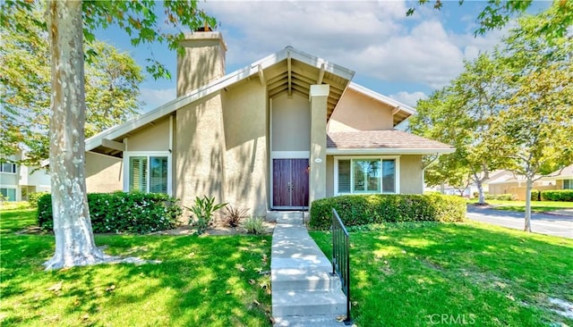 5855 Via Sonora Unit 39, Yorba Linda, CA 92887 - mid-century modern home featuring stucco siding, a chimney, and a front lawn