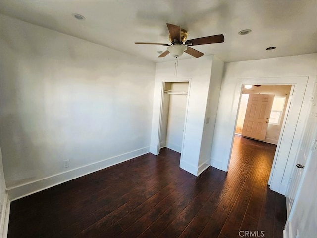 1210 W Manchester Ave, Los Angeles, CA 90044 - unfurnished bedroom with dark wood-style flooring, baseboards, a closet, and a ceiling fan