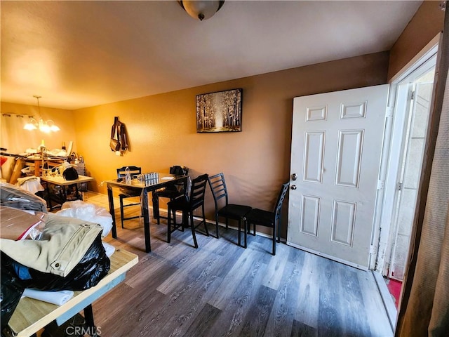 1210 W Manchester Ave, Los Angeles, CA 90044 - dining area with dark wood-style flooring and a chandelier