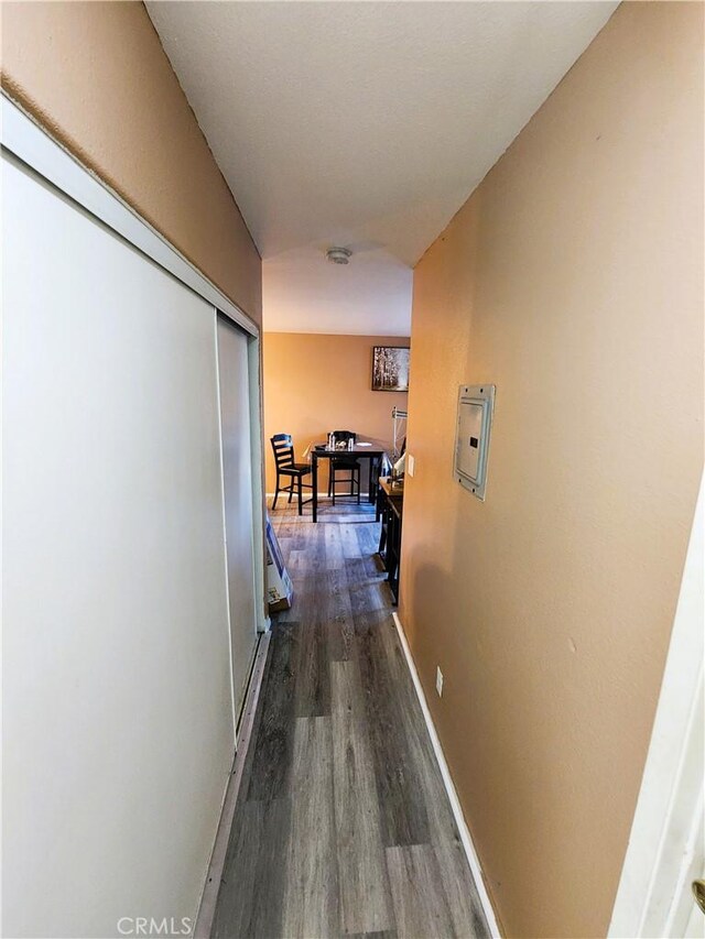 1210 W Manchester Ave, Los Angeles, CA 90044 - hallway with dark wood-style flooring and baseboards