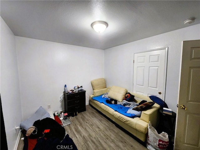 1210 W Manchester Ave, Los Angeles, CA 90044 - bedroom with wood finished floors, a textured ceiling, and baseboards