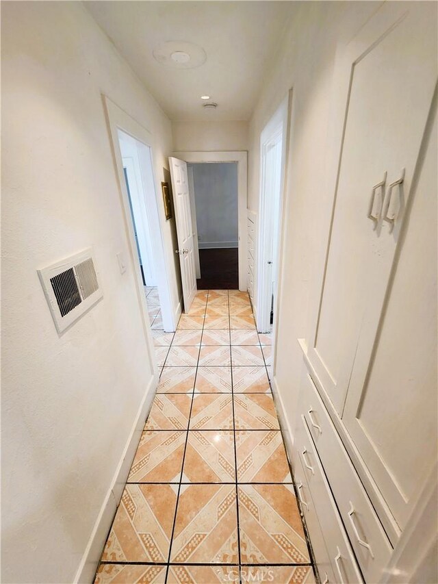 1210 W Manchester Ave, Los Angeles, CA 90044 - corridor featuring light tile patterned floors and baseboards