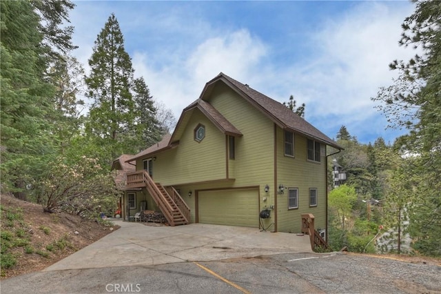 26349 Walnut Hills Dr, Lake Arrowhead, CA 92391 - view of front facade with stairs, concrete driveway, and a garage