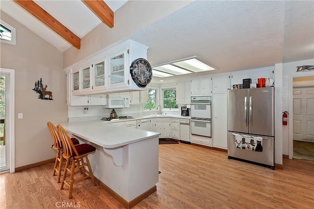 26349 Walnut Hills Dr, Lake Arrowhead, CA 92391 - kitchen featuring appliances with stainless steel finishes, a peninsula, a sink, and light countertops