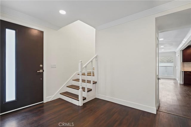 entrance foyer featuring wood finished floors, stairs, recessed lighting, and baseboards