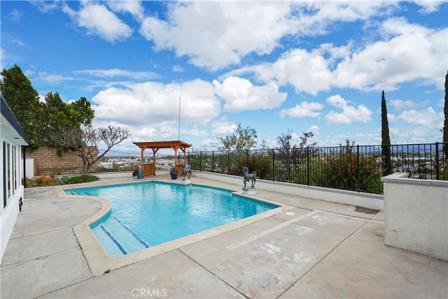 view of swimming pool with a patio and fence