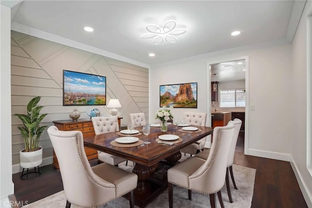 dining room with crown molding, dark wood-style floors, baseboards, and recessed lighting