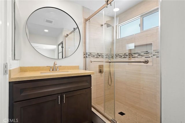 full bath featuring a stall shower and vanity