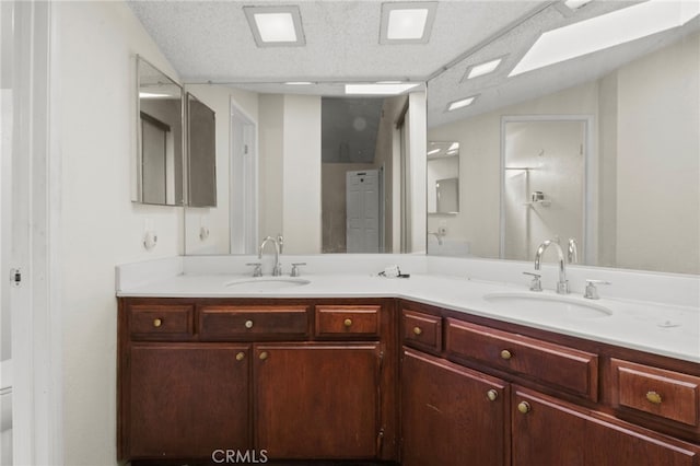 bathroom featuring double vanity and toilet