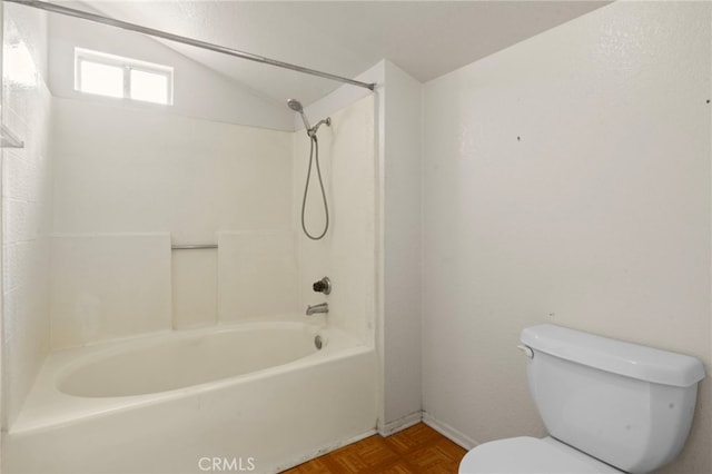 bathroom with toilet, vaulted ceiling, and shower / bathtub combination