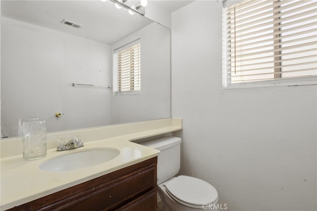 half bathroom with toilet and vanity