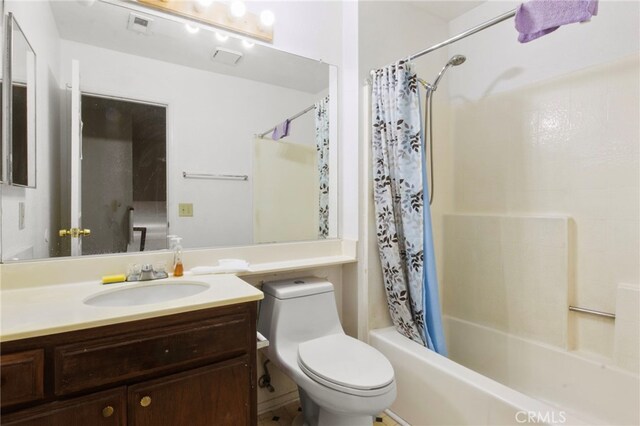 bathroom with shower / bathtub combination with curtain, toilet, and vanity