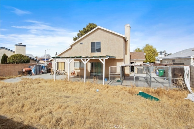 rear view of property with a gate, a fenced backyard, a patio area, and stucco siding