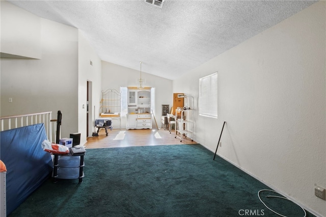 carpeted living room featuring lofted ceiling and a textured ceiling