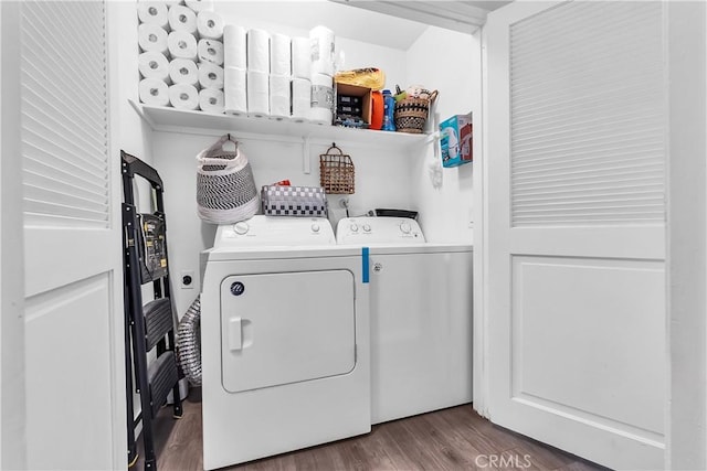 washroom featuring washing machine and dryer and wood finished floors