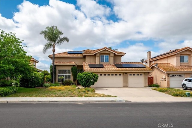 39680 Glenwood Ct, Murrieta, CA 92563 - mediterranean / spanish-style home with roof mounted solar panels, driveway, stucco siding, a tile roof, and a garage