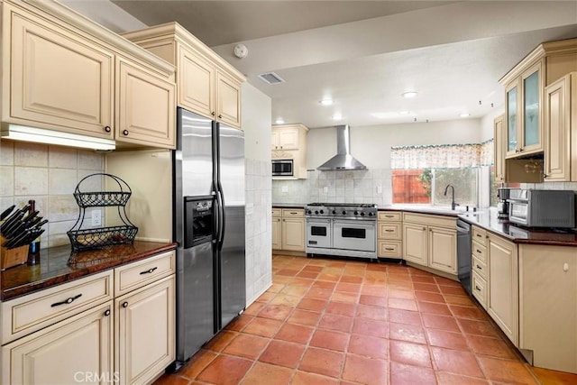 39680 Glenwood Ct, Murrieta, CA 92563 - kitchen with appliances with stainless steel finishes, cream cabinetry, wall chimney range hood, decorative backsplash, and a sink