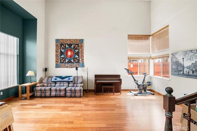 39680 Glenwood Ct, Murrieta, CA 92563 - living area with wood finished floors, a towering ceiling, and baseboards
