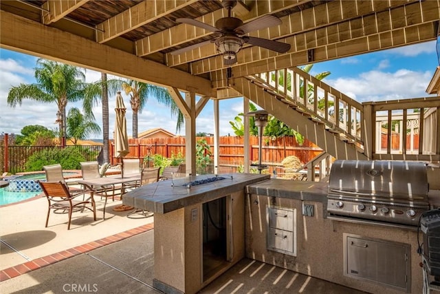39680 Glenwood Ct, Murrieta, CA 92563 - view of patio / terrace featuring a grill, an outdoor kitchen, a fenced backyard, and stairs