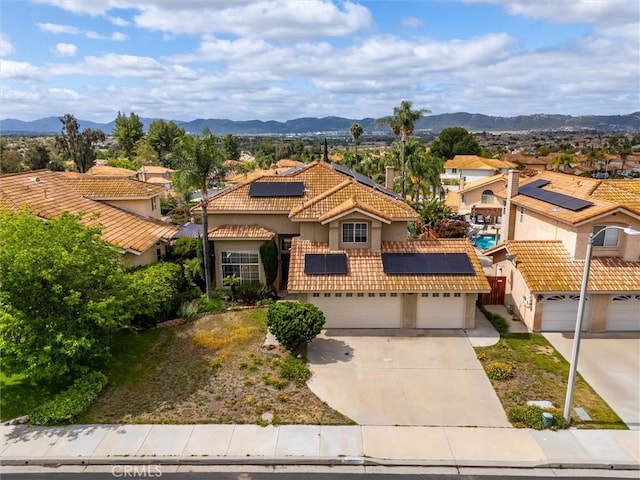 39680 Glenwood Ct, Murrieta, CA 92563 - mediterranean / spanish house with a tiled roof, solar panels, concrete driveway, stucco siding, and a residential view