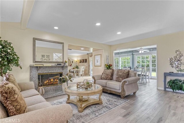 17027 Simonds St, Granada Hills, CA 91344 - living area featuring wood finished floors, recessed lighting, a high end fireplace, ceiling fan, and beamed ceiling