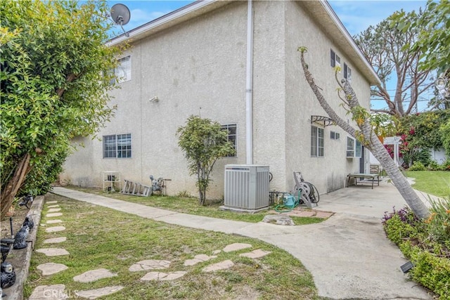 17027 Simonds St, Granada Hills, CA 91344 - view of property exterior featuring cooling unit, stucco siding, and a patio