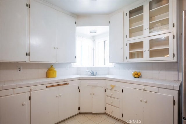 1315 S Walker Ave, San Pedro, CA 90731 - kitchen with decorative backsplash, a sink, and glass insert cabinets