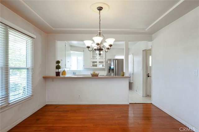 1315 S Walker Ave, San Pedro, CA 90731 - unfurnished dining area featuring a chandelier, light wood-type flooring, and baseboards