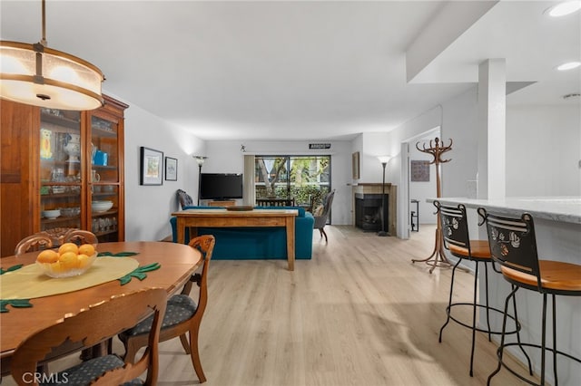 254 E Fern Ave Unit 108, Redlands, CA 92373 - dining area featuring light wood-style floors and a wood stove