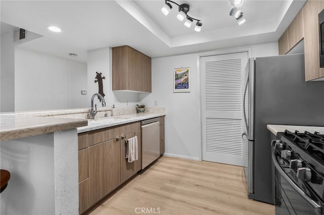 254 E Fern Ave Unit 108, Redlands, CA 92373 - kitchen with dishwasher, a sink, gas range oven, light wood-style flooring, and baseboards