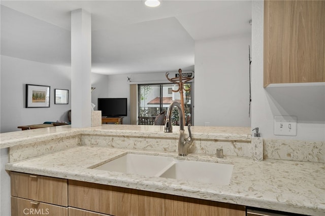 254 E Fern Ave Unit 108, Redlands, CA 92373 - kitchen featuring a sink, light stone counters, open floor plan, and light brown cabinets