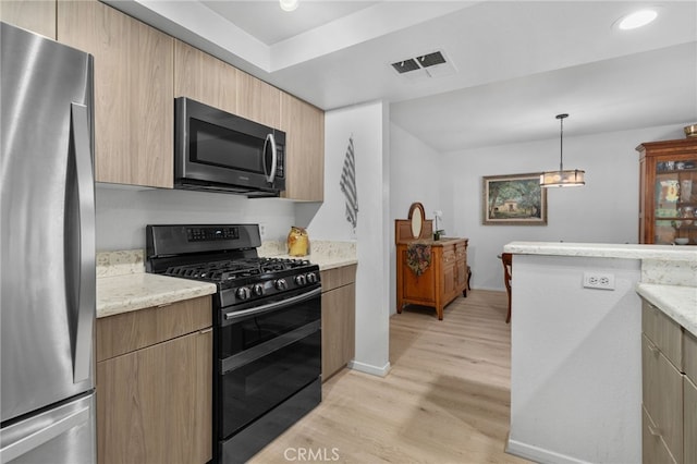254 E Fern Ave Unit 108, Redlands, CA 92373 - kitchen featuring appliances with stainless steel finishes, light wood-type flooring, modern cabinets, decorative light fixtures, and baseboards